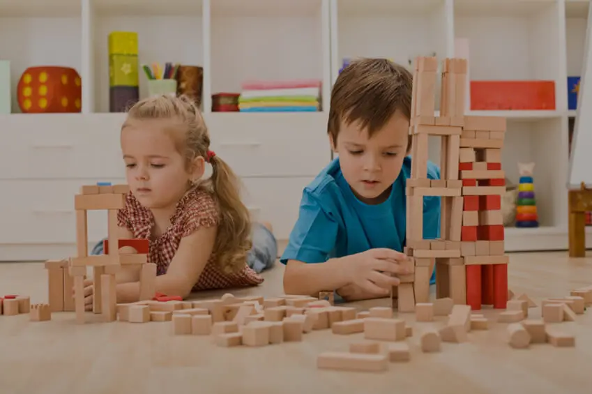 Kids Playing With Wooden Blocks Laying on the Floor